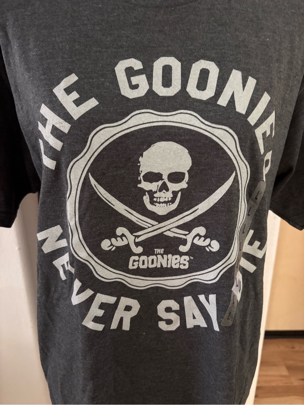 The Goonies Never Say Die Skull Logo Tee - SZ L—Charcoal NWT. - Picture 2 of 4